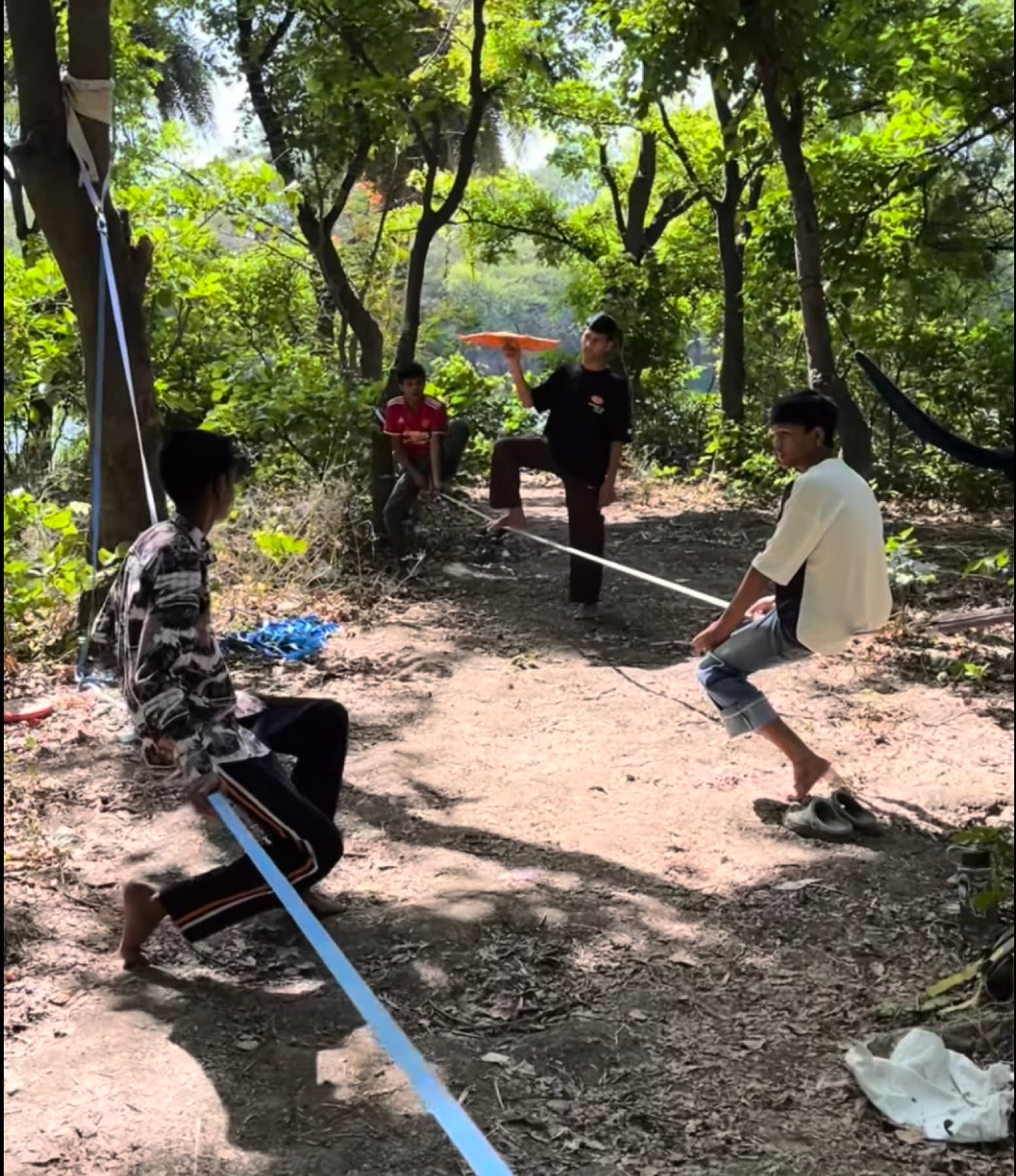 Junglee Crew members balancing and playing together on slacklines outdoors