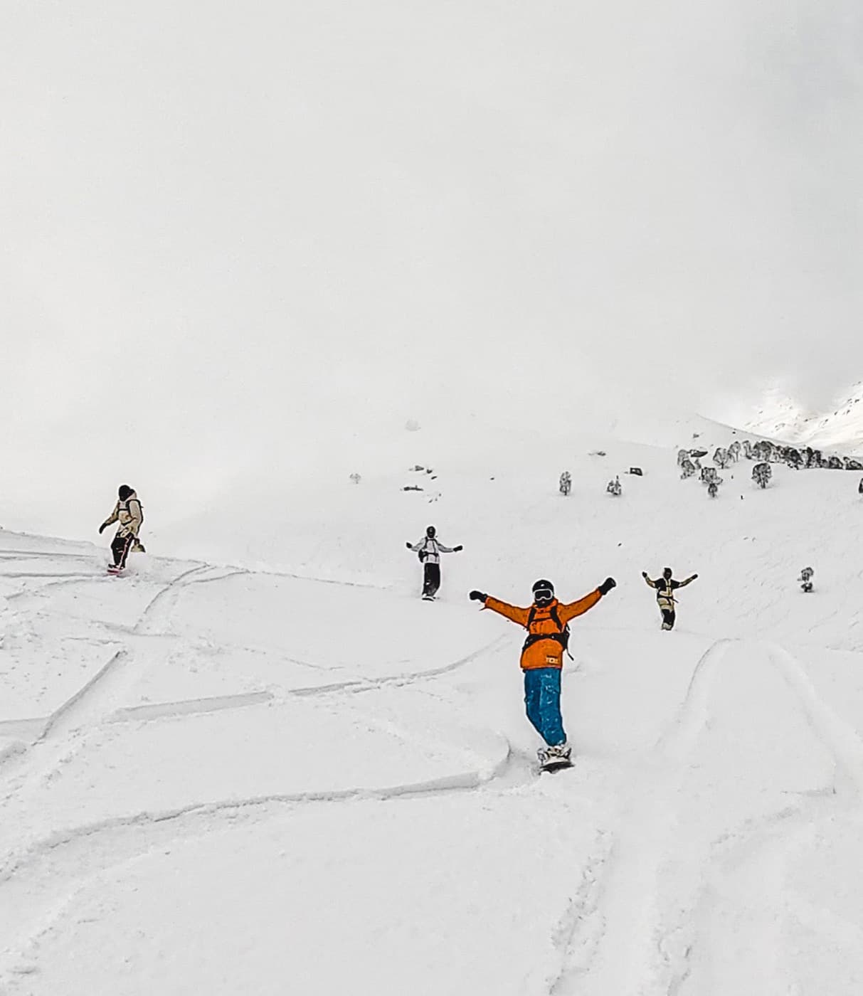 Snowboarders riding Himalayan powder in India