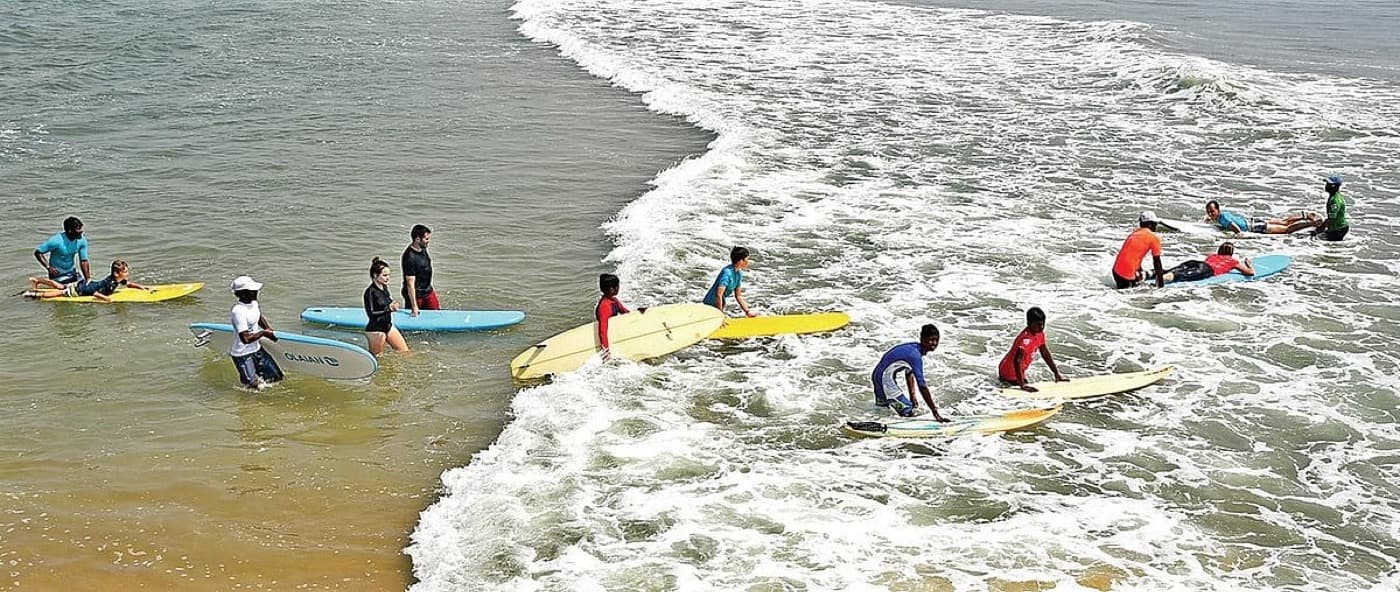 A surfing lesson with the local community at Covelong in India